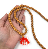 8mm Sandalwood Mala Bead on hand for size reference
