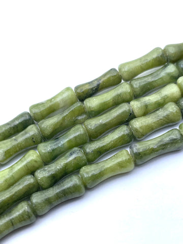 Green nephrite jade stone beads with a natural marbled texture, arranged diagonally on a plain white background.