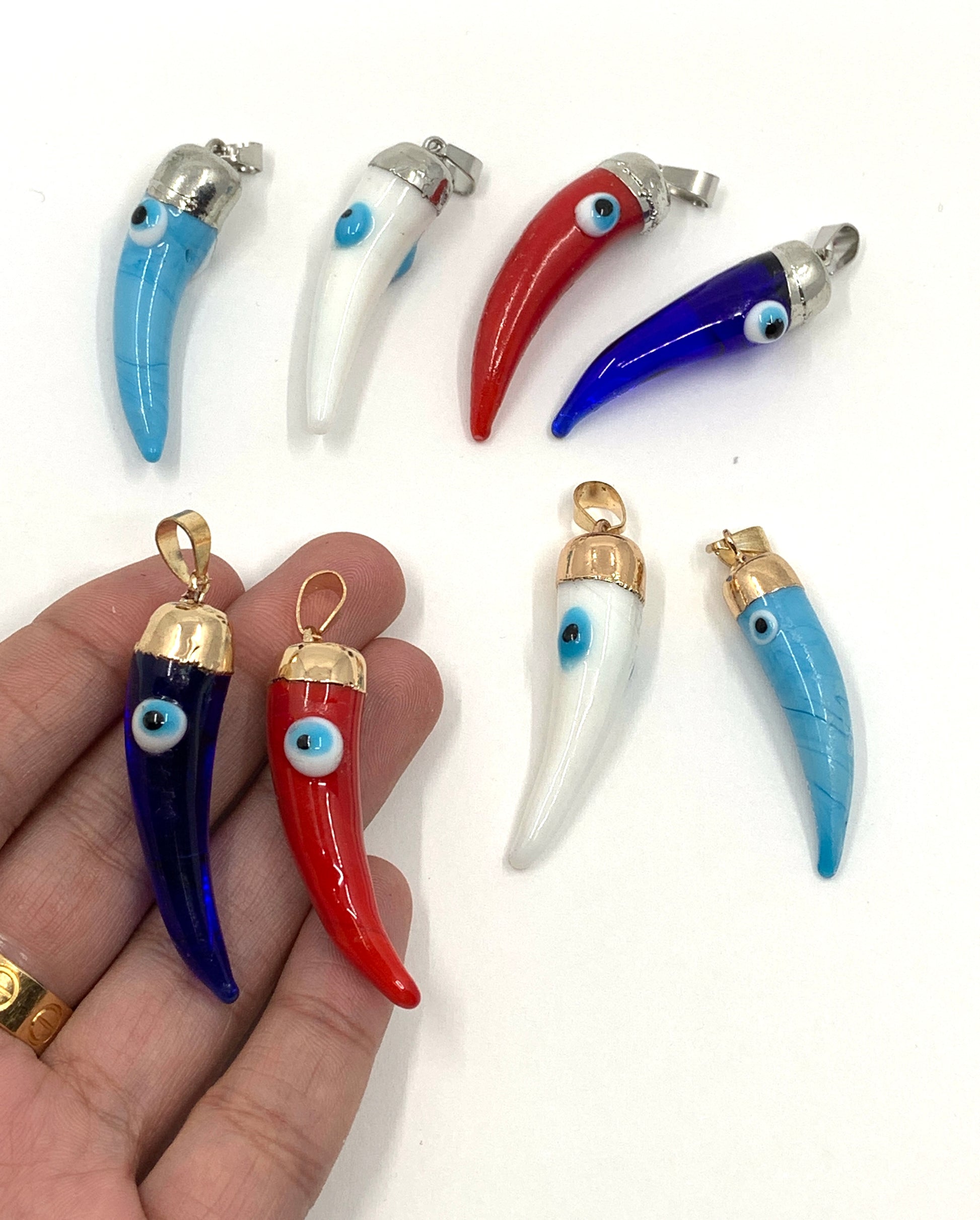 Horn pendants on hand for size reference