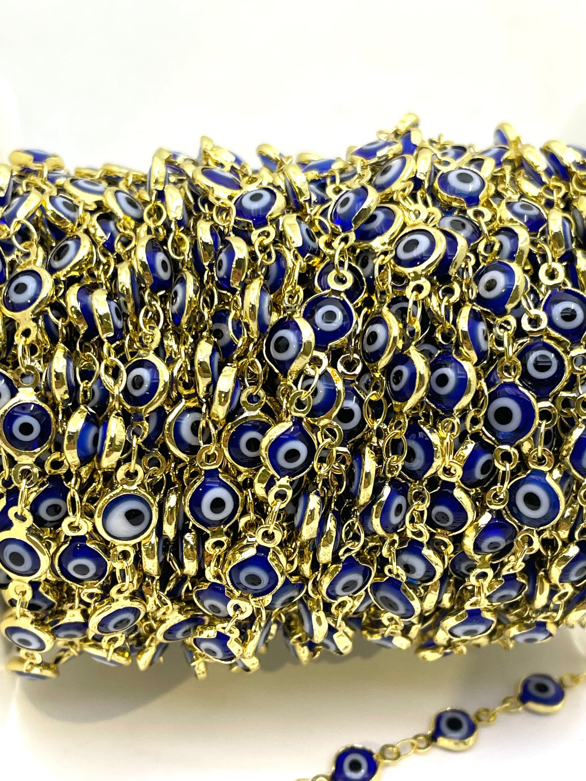 A close-up of a spool of gold chain 