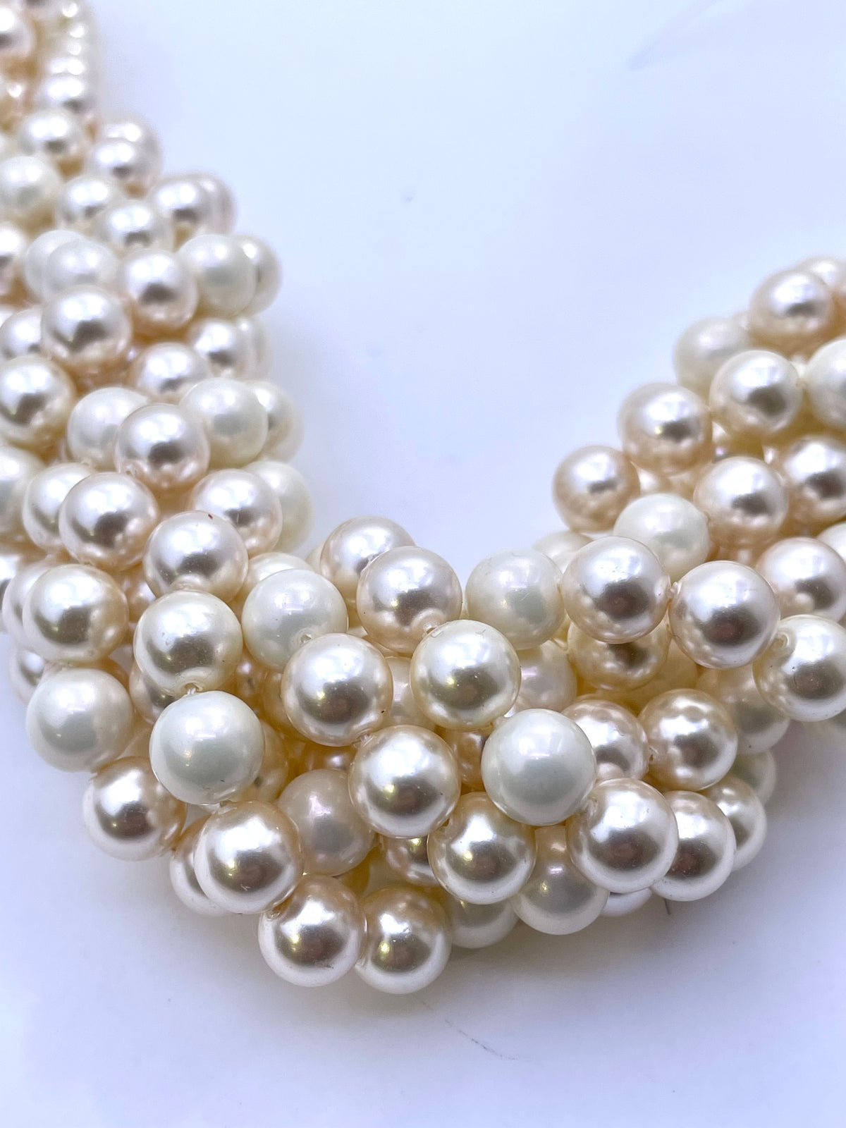 A close-up of a round ivory glow shell pearls