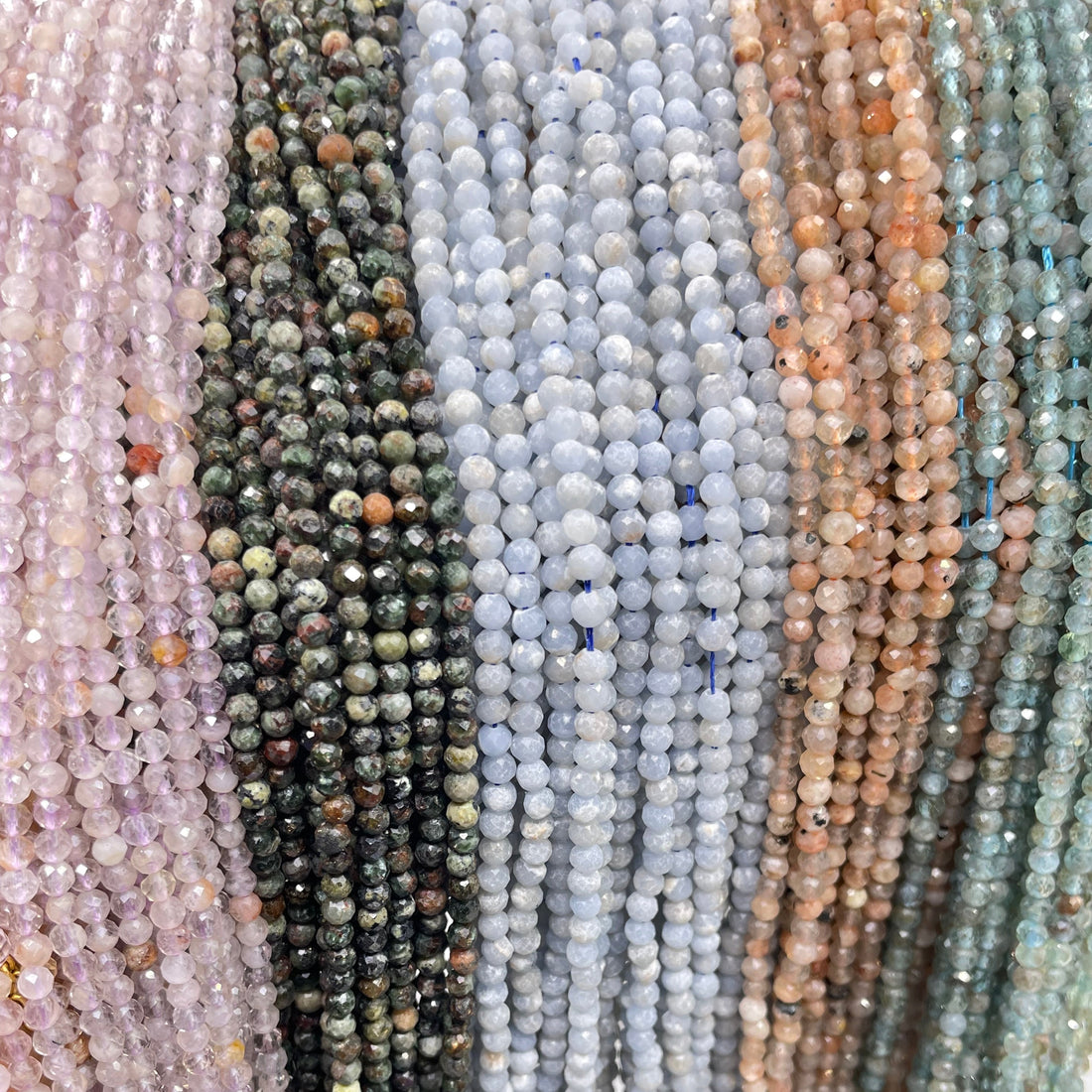 3mm round faceted light amethyst, serpentine, angelite, sunstone and light apatite displayed from left to right.