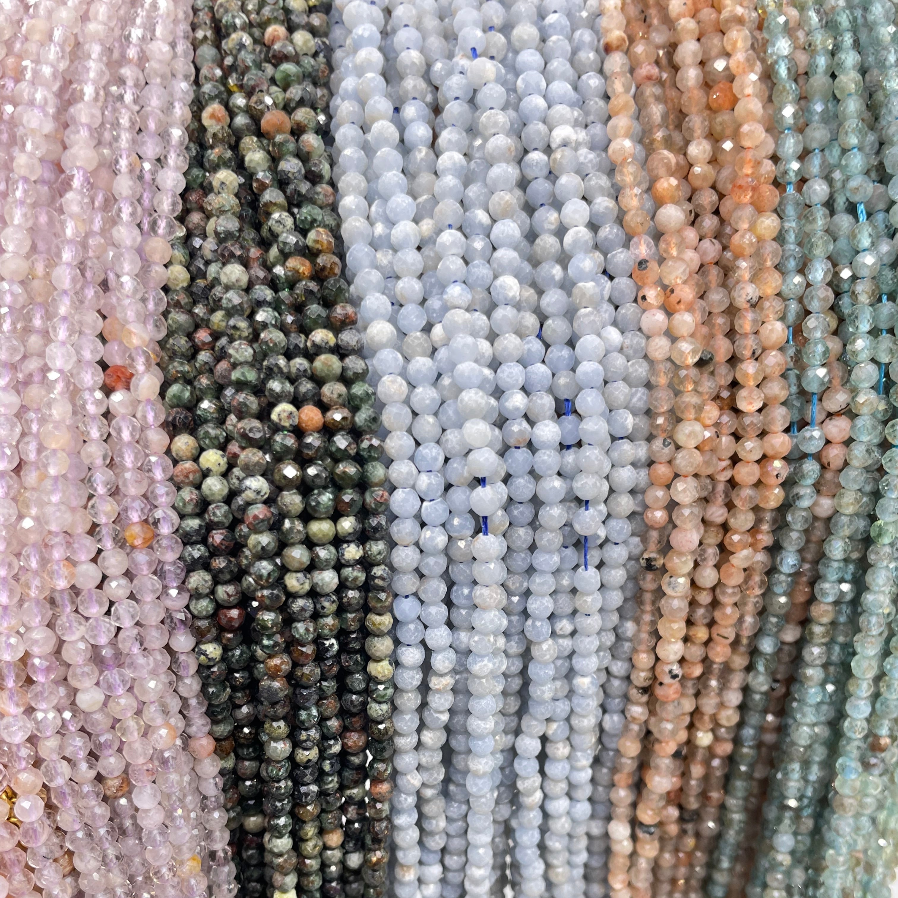 3mm round faceted light amethyst, serpentine, angelite, sunstone and light apatite displayed from left to right.