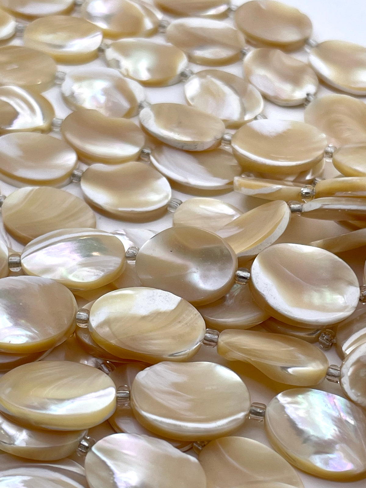 Oval MOP beads in caramel color, against white background