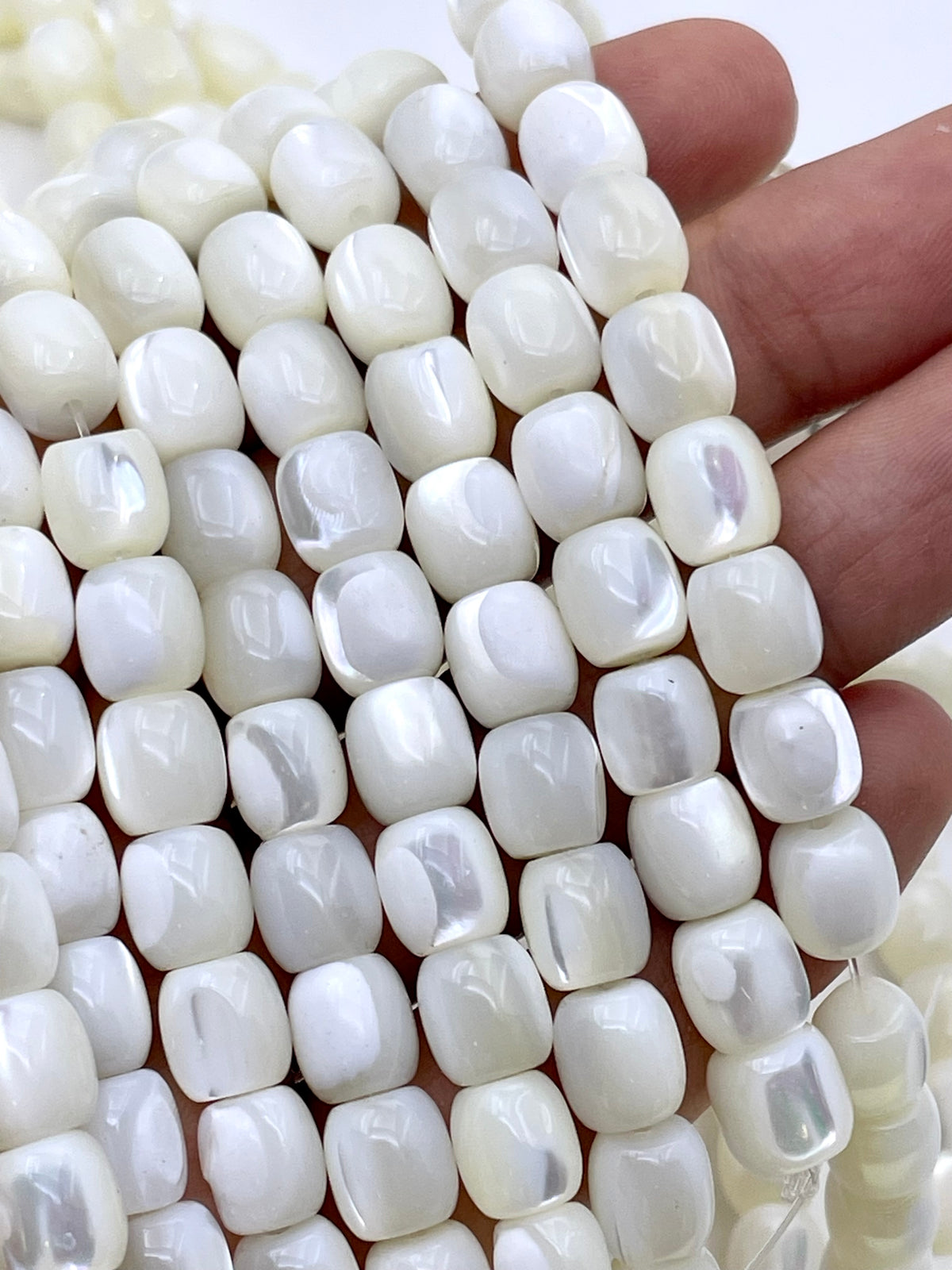 White MOP rounded tube beads on hand for size reference