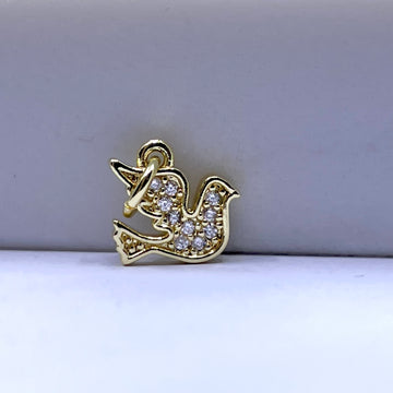 A gold bird-shaped charm or pendant decorated with small clear stones, photographed on a plain light gray background.