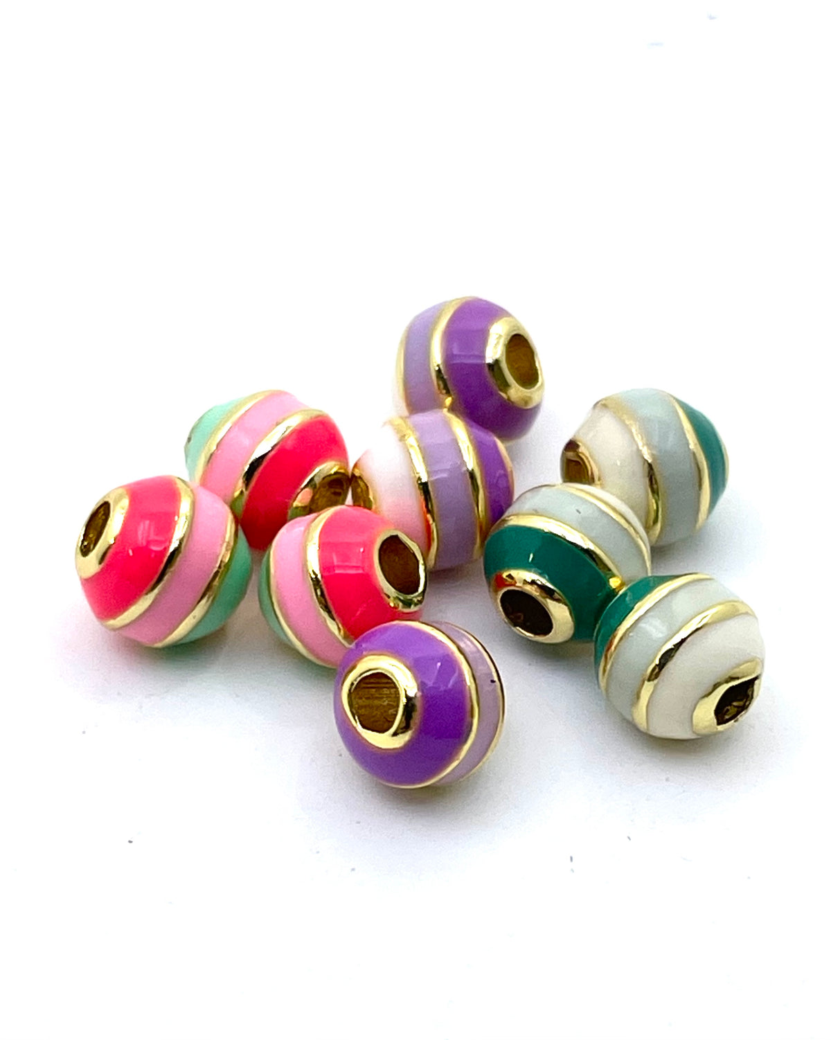 A group of colorful striped brass bead charms with gold-plated edges, displayed on a clean white background.