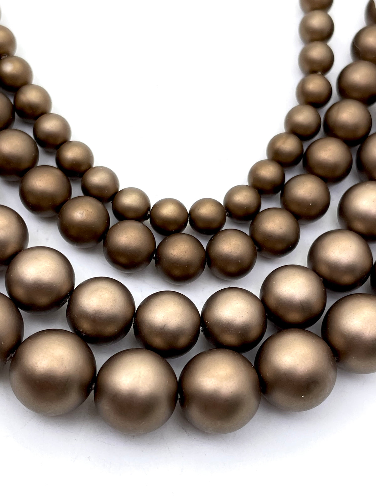 Pearlescent Chocolate brown shell pearls in 4 sizes for size comparison.