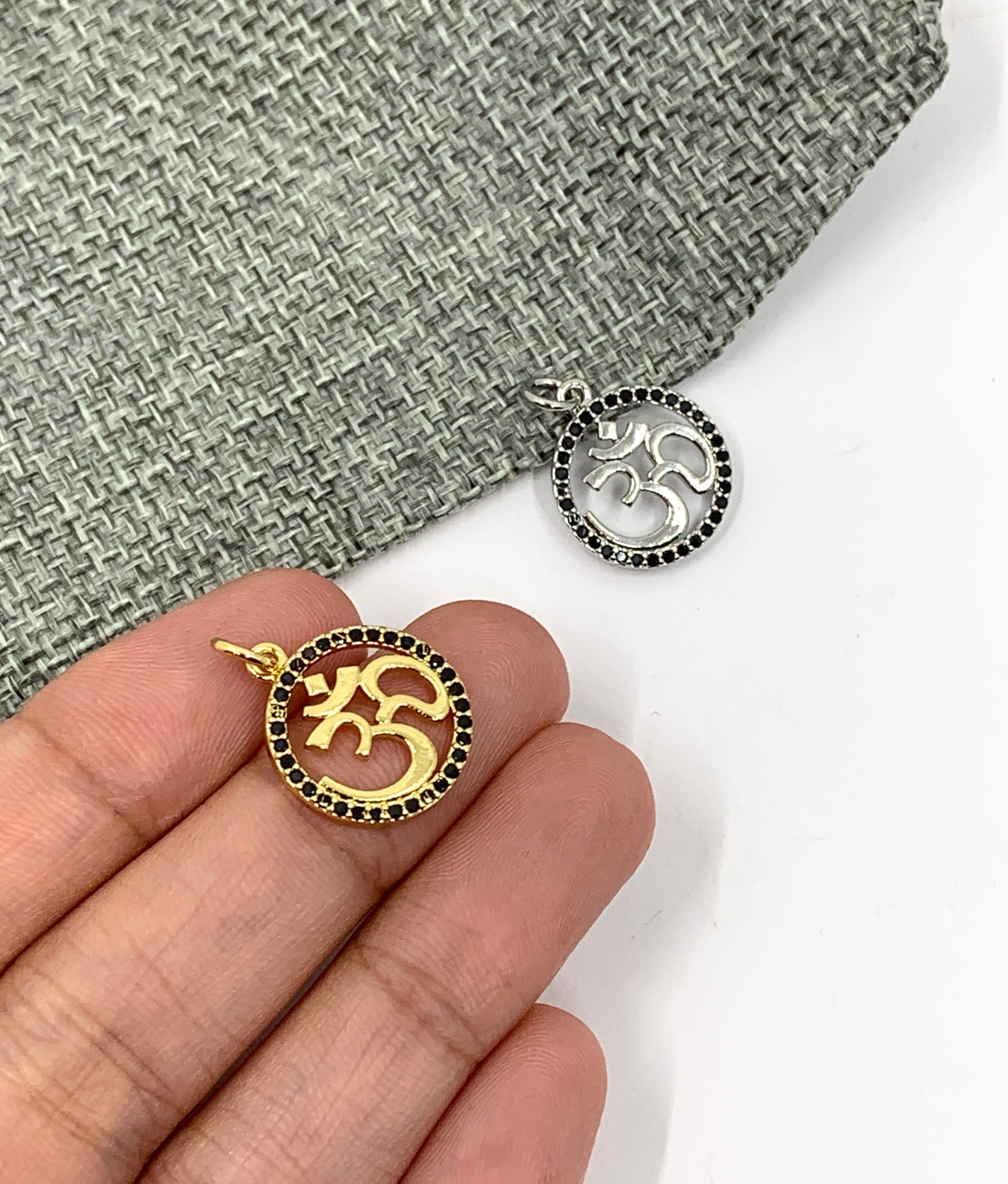 Round Gold OM Pendant on hand for size reference