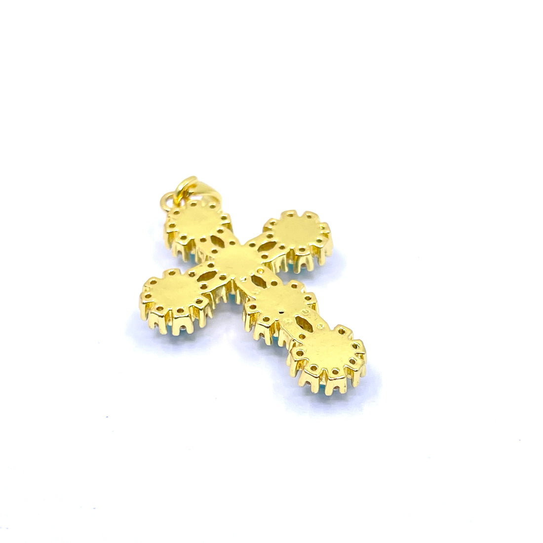 A gold cross pendant featuring SIX round turquoise-blue cabochon stones, each surrounded by a halo of small clear crystals, set against a plain white background.