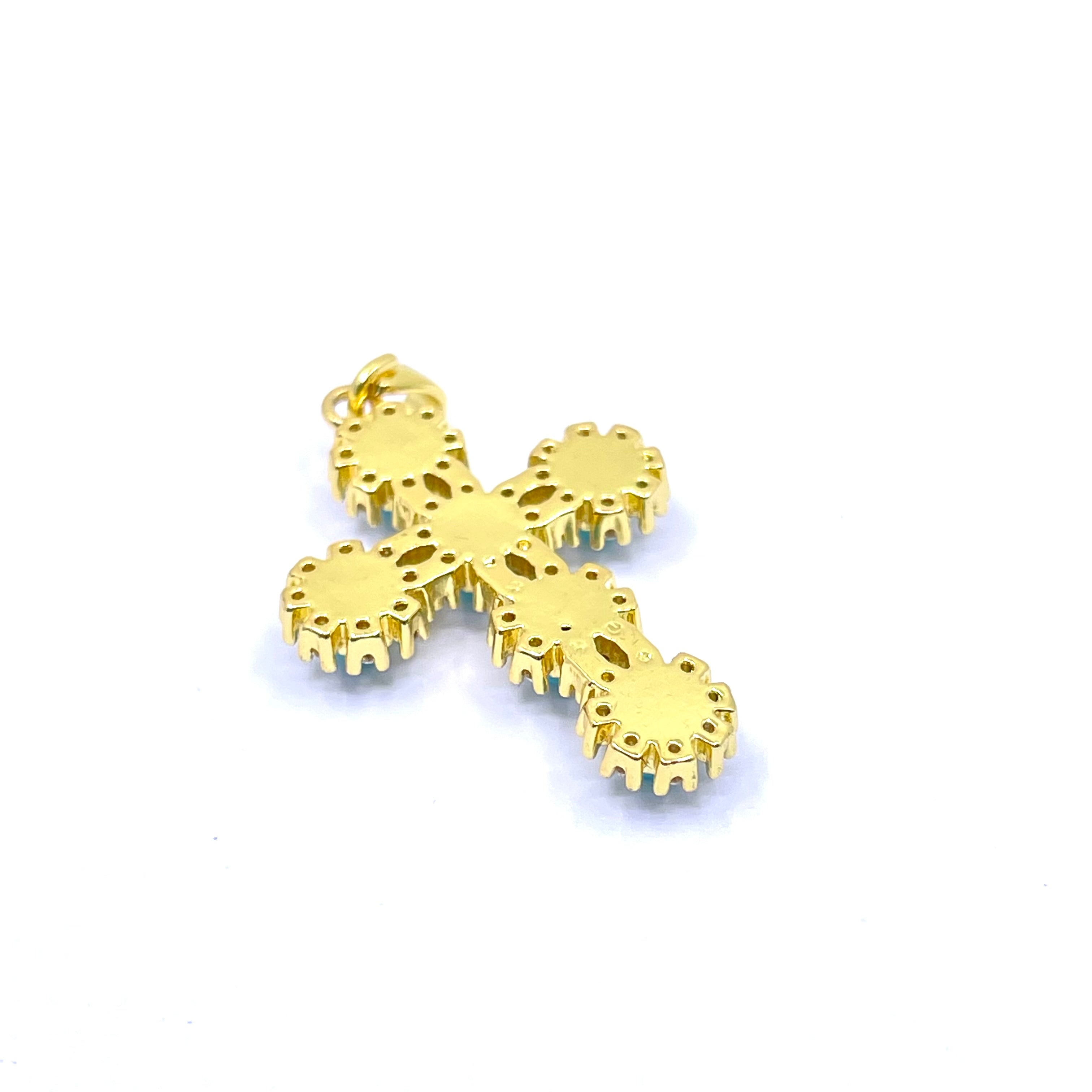 A gold cross pendant with intricate cutout details and a small top loop, shown on a plain white background.
