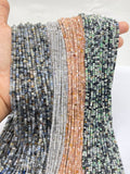 Kyanite, labradorite, moonstone, variscite beads held in hand to show the size.