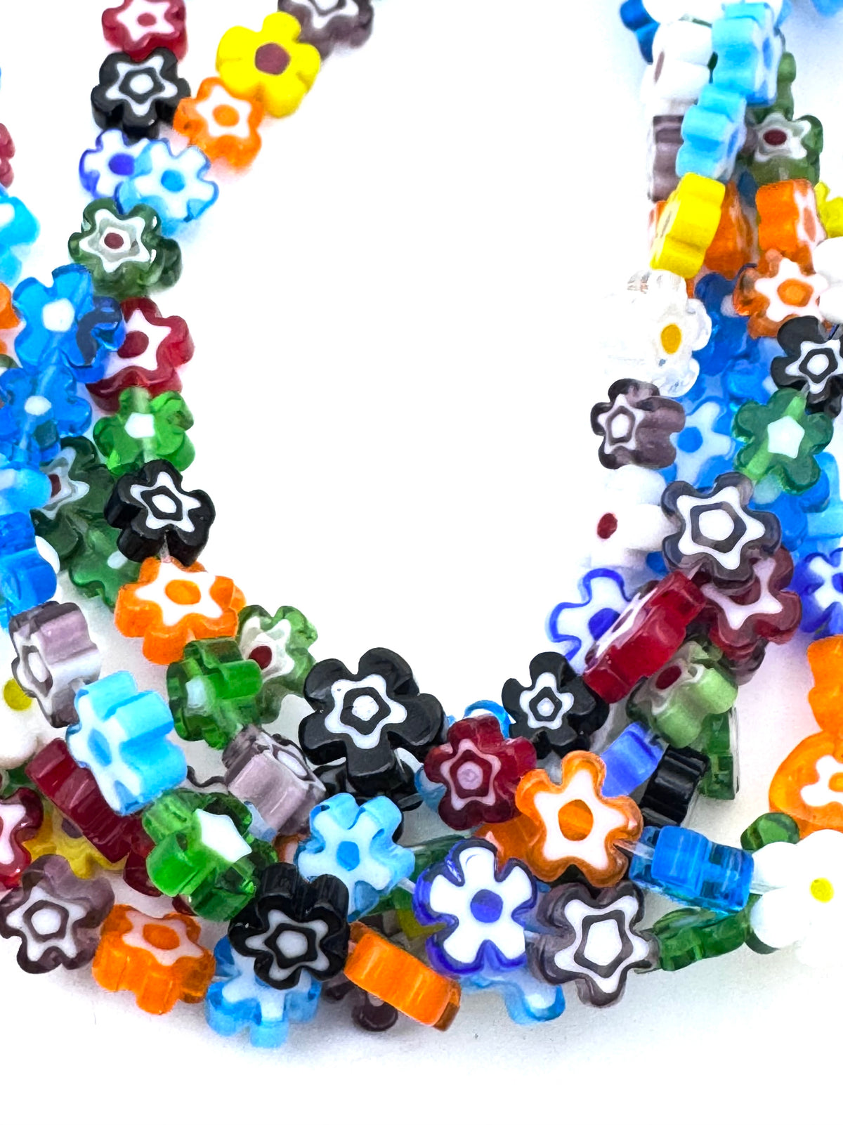A close-up of a multicolor translucent flower-shaped beads in various colors including blue, green, orange, red, yellow, black, and white, arranged in a U-shape on a plain white background.