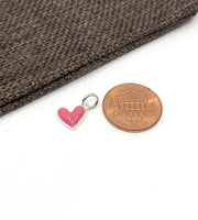 Pink heart charm with coin for size reference