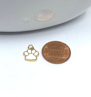 White paw print charm with a coin for size reference
