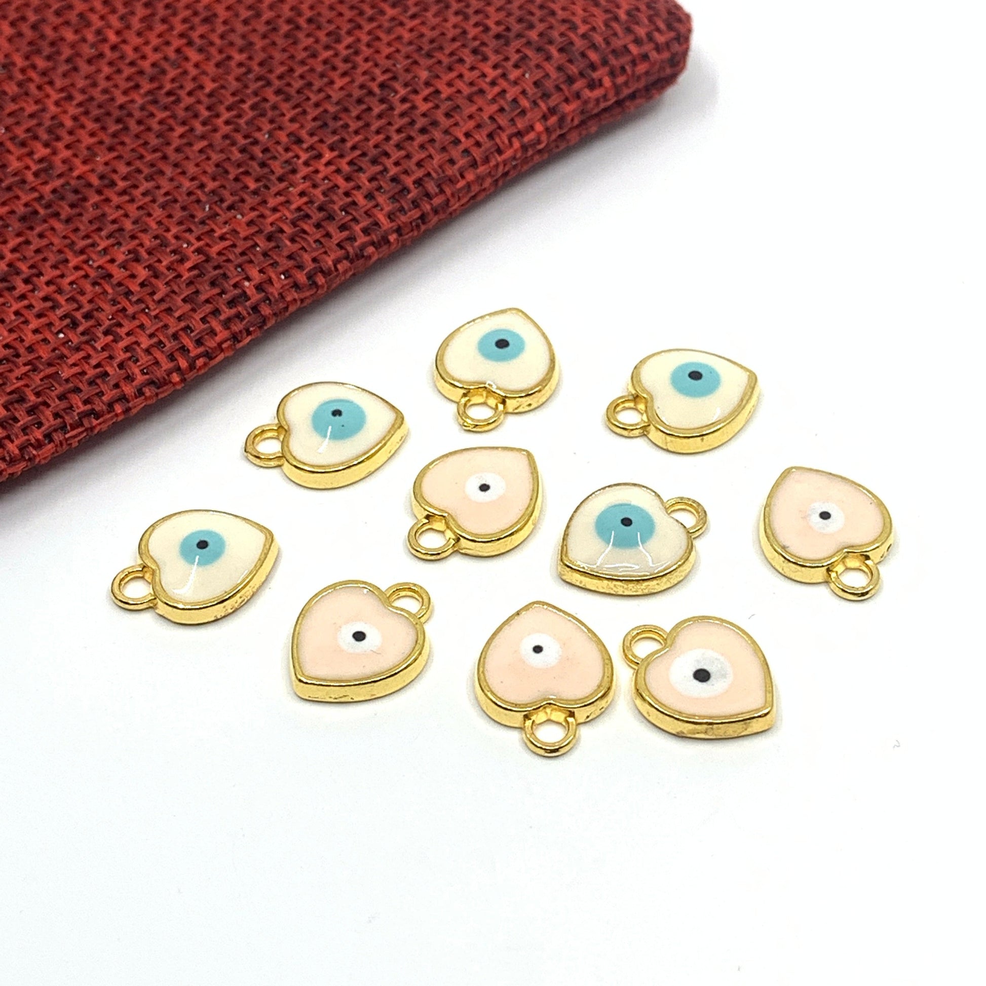 White and pink enamel heart evil eye charm