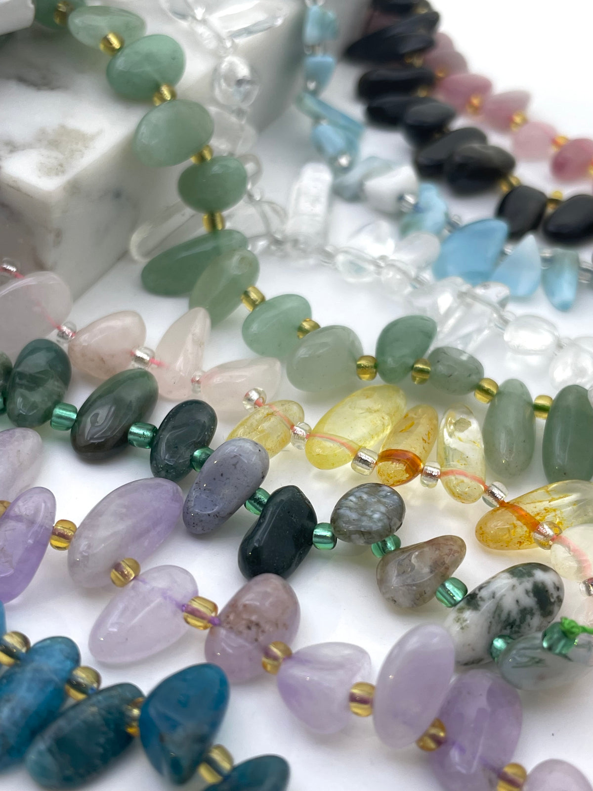 Raw Tooth Gemstone Beads against white background