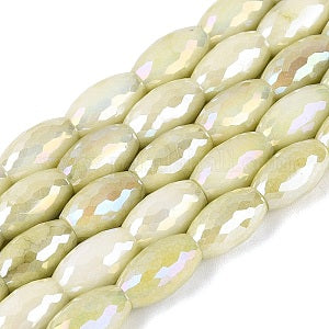 Row of light green faceted beads on a white background