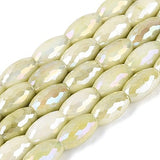 Row of light green faceted beads on a white background