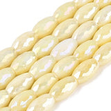 String of light yellow faceted beads on a white background