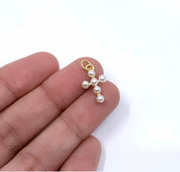Pearl cross on hand for size reference