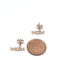 Mom writing stud earrings in rose gold color, compared to a coin for size reference