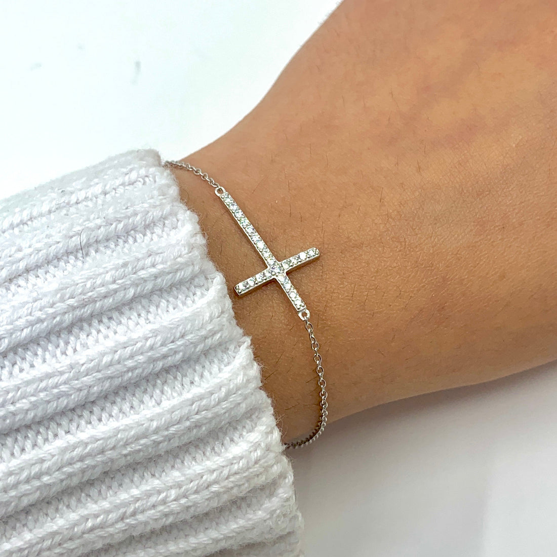 Sterling Silver CZ Cross Bracelet worn on wrist for size reference