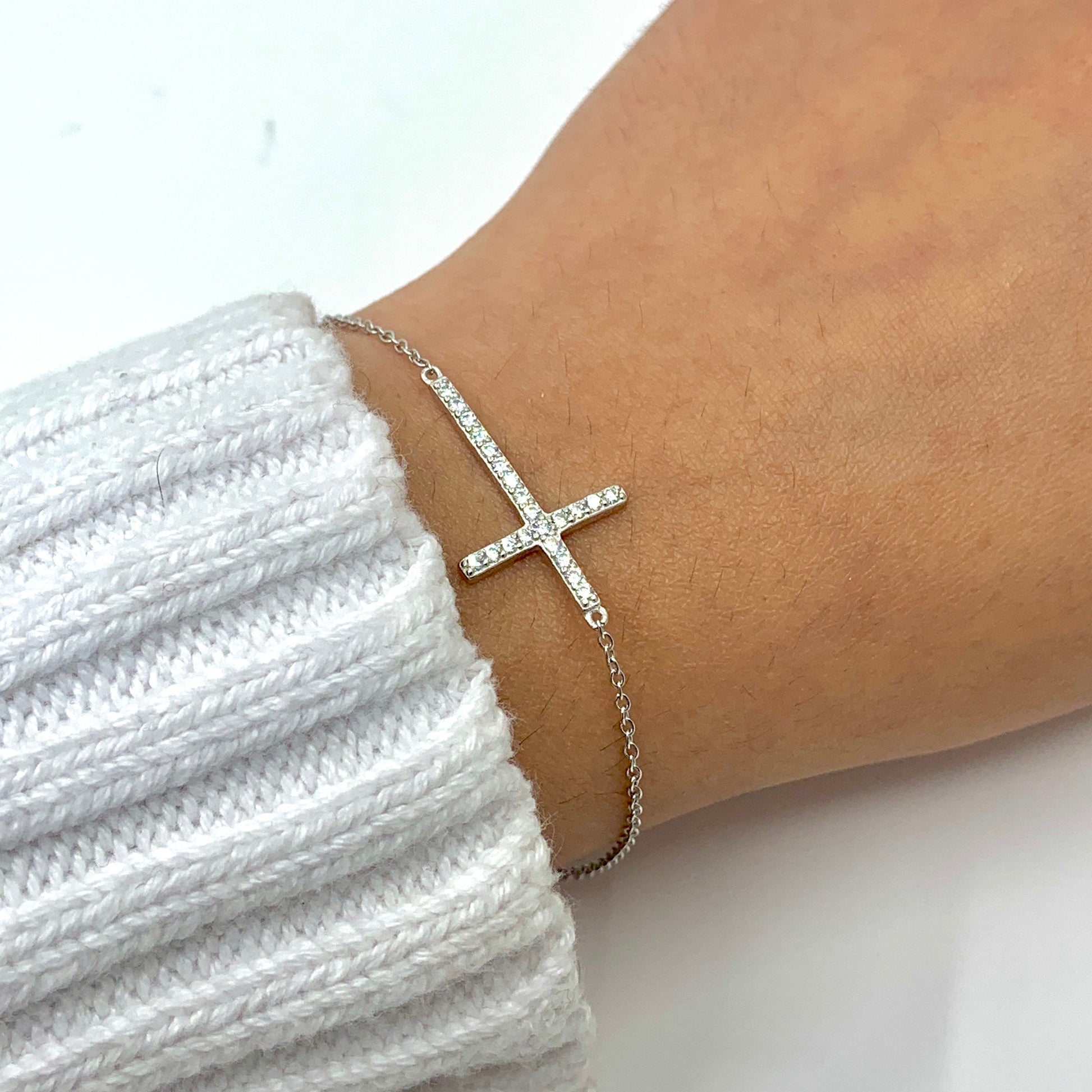 Sterling Silver CZ Cross Bracelet worn on wrist for size reference