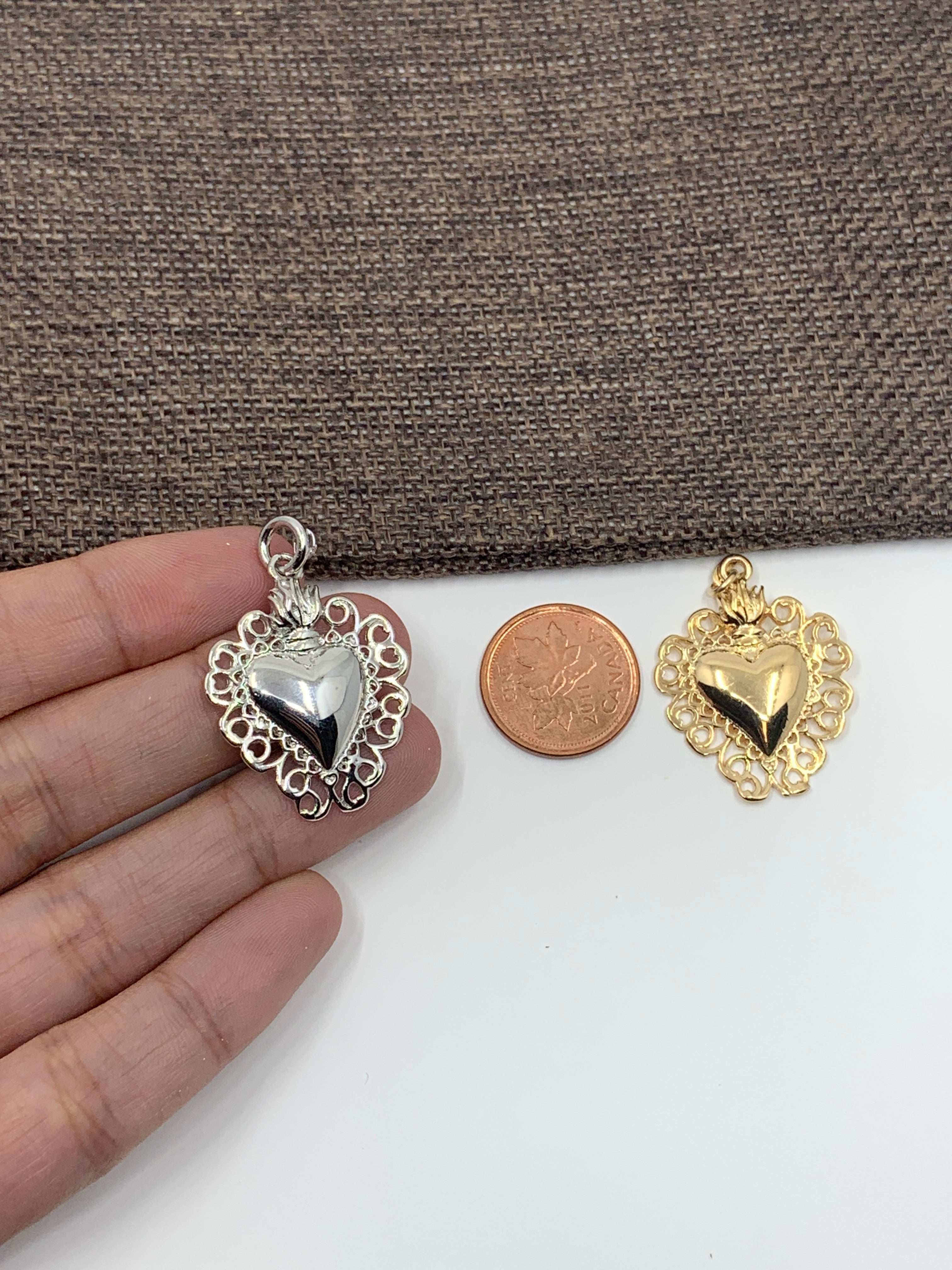 Ex-voto heart pendant on hand for size reference