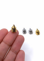 Trojan Helmet CZ Beads in gold and silver colors. Beads shown on hand for size reference