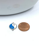 Enamel yin yang connector with a coin for size reference