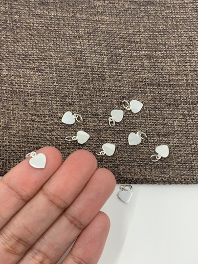 Sterling Silver Mini Flat Heart Charm on hand for size reference