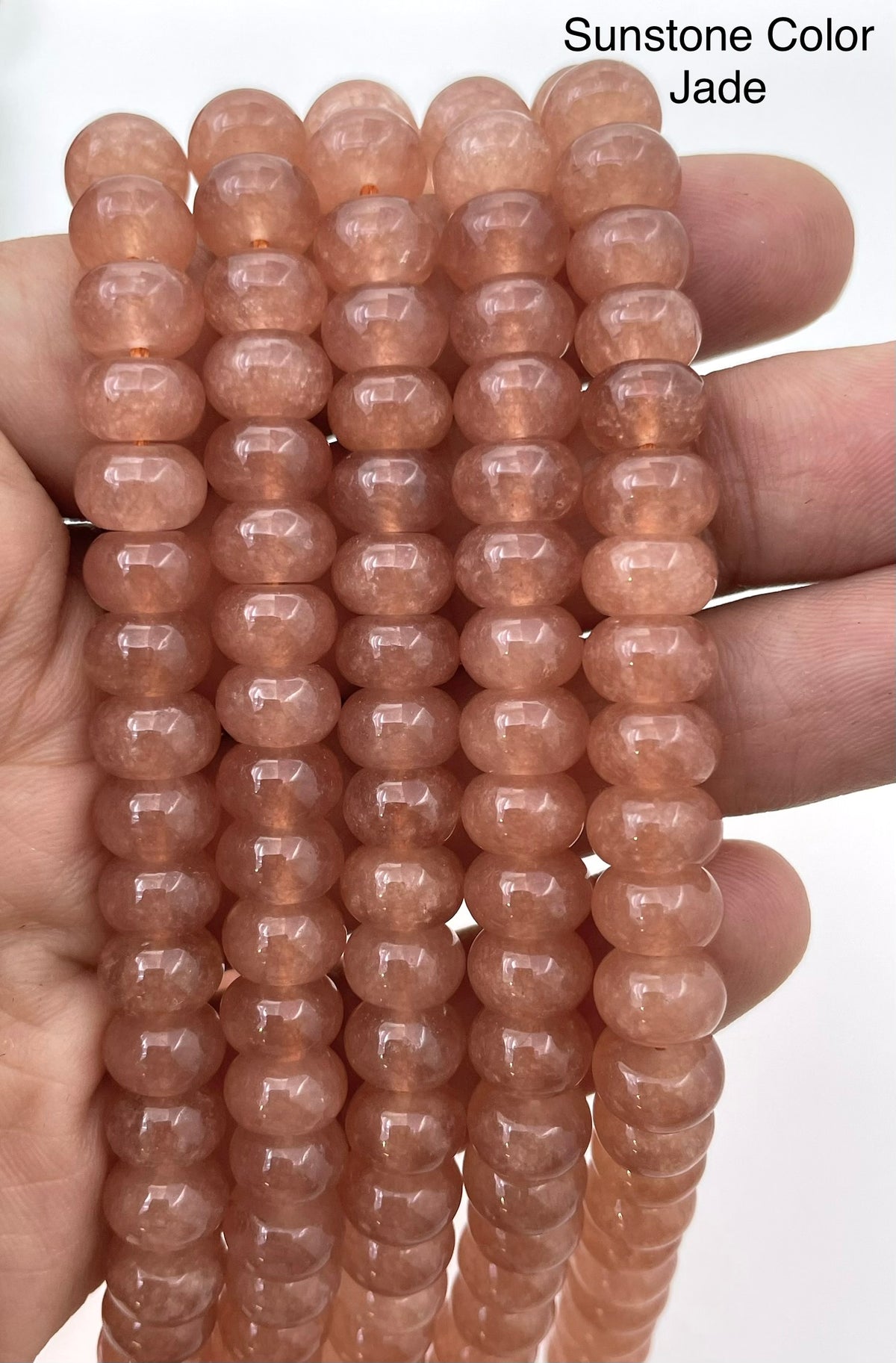Sunstone color jade on hand for size reference