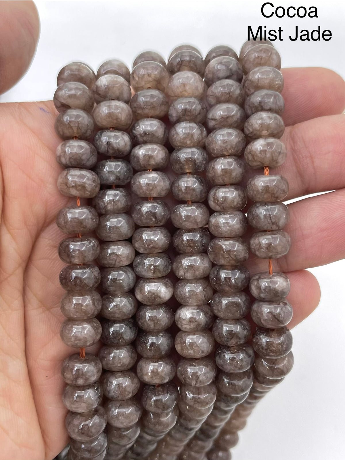 Coca mist jade on a hand for size reference