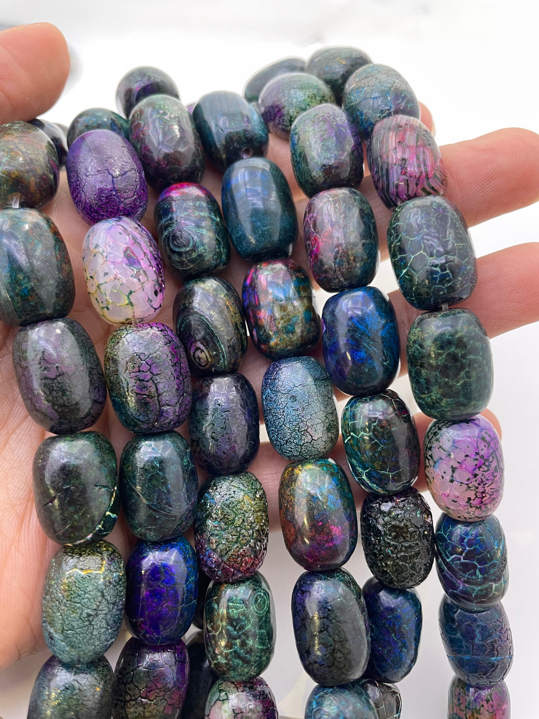 Galaxy Agate beads on a hand for size reference