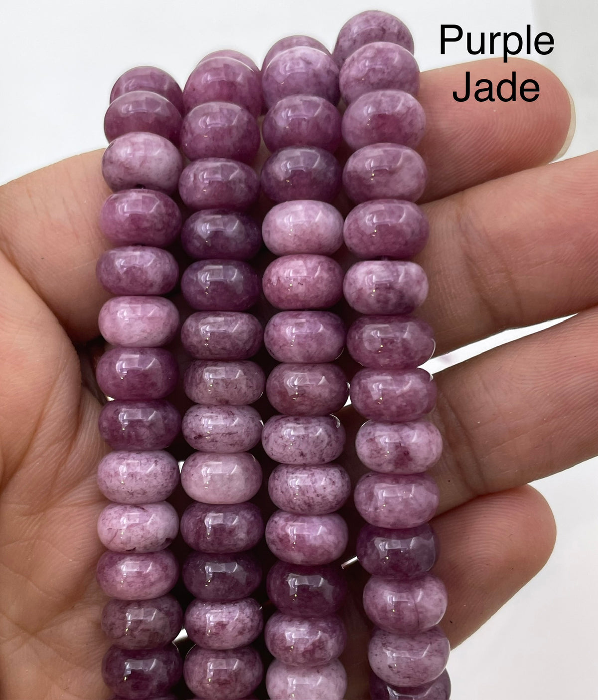 Purple jade on hand for size reference
