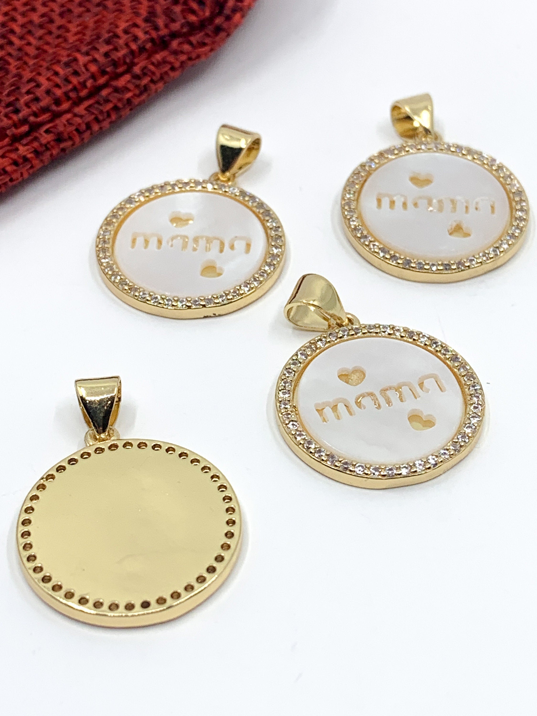 "Mama writing with 2 hearts" on flat round shell pearl charm pendant with clear cz stones around, 18k gold plated