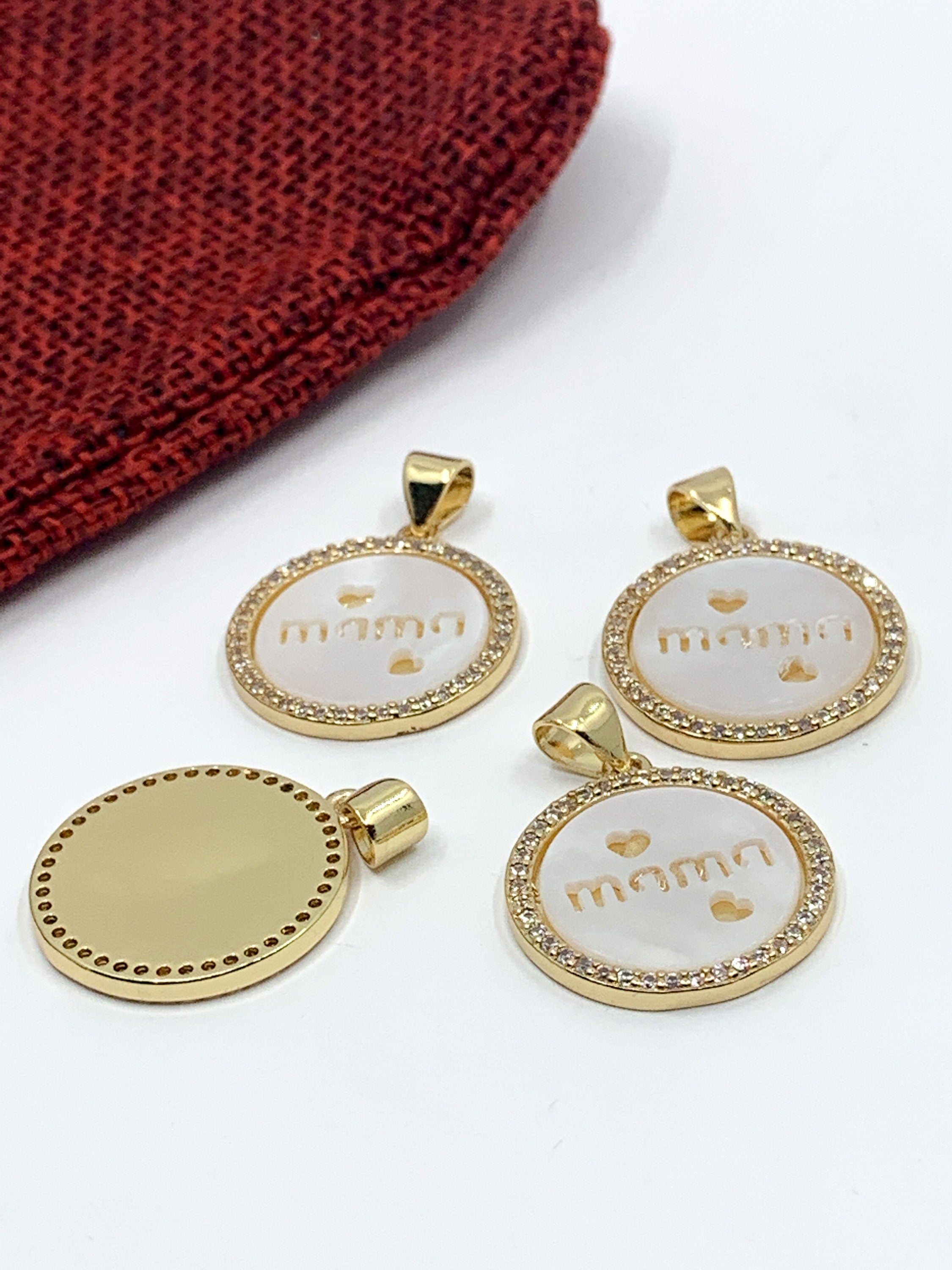 "Mama writing with 2 hearts" on flat round shell pearl charm pendant with clear cz stones around, 18k gold plated