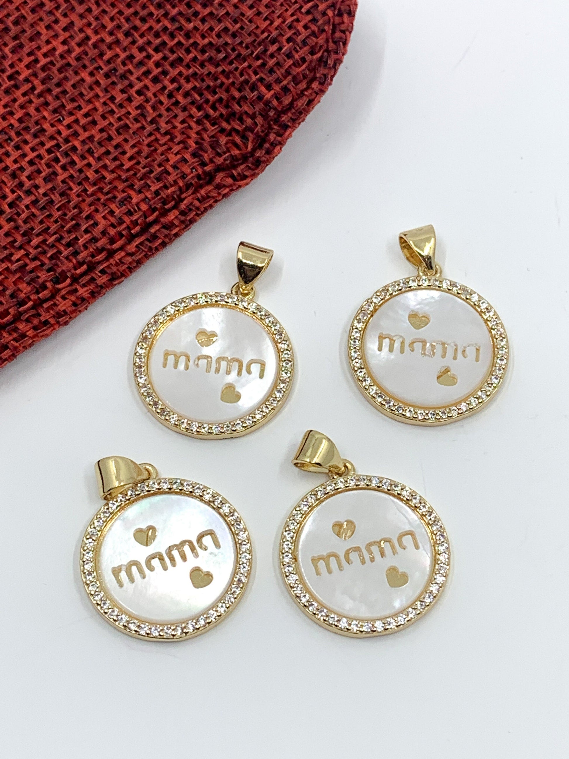 "Mama writing with 2 hearts" on flat round shell pearl charm pendant with clear cz stones around, 18k gold plated