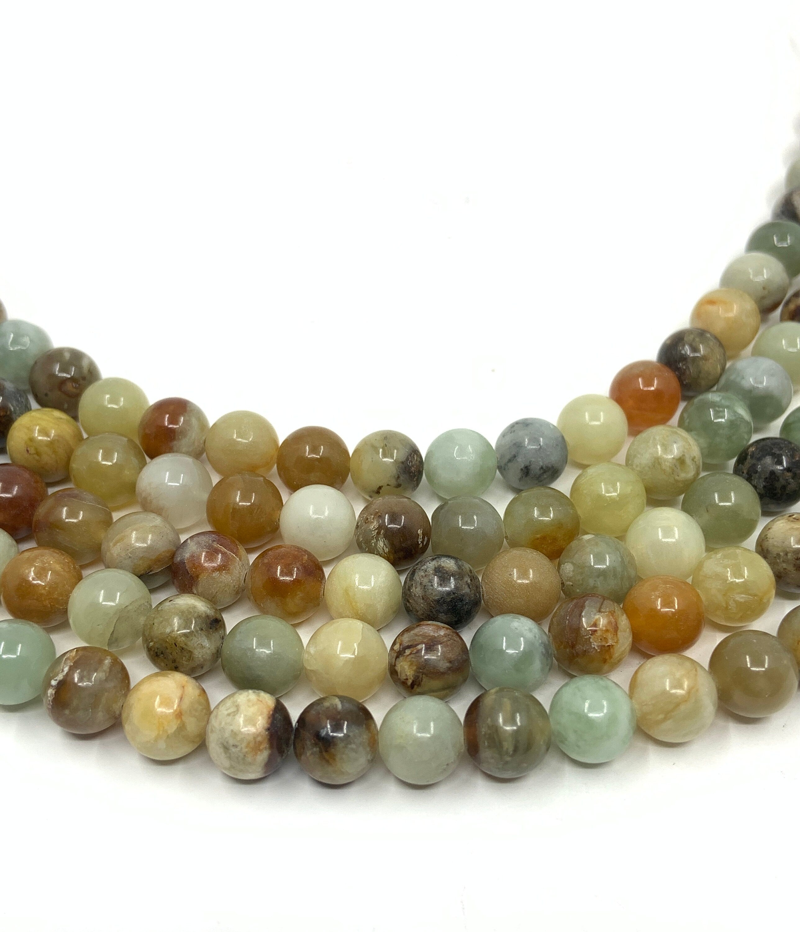 5 strands of 8mm flower jade against a white background