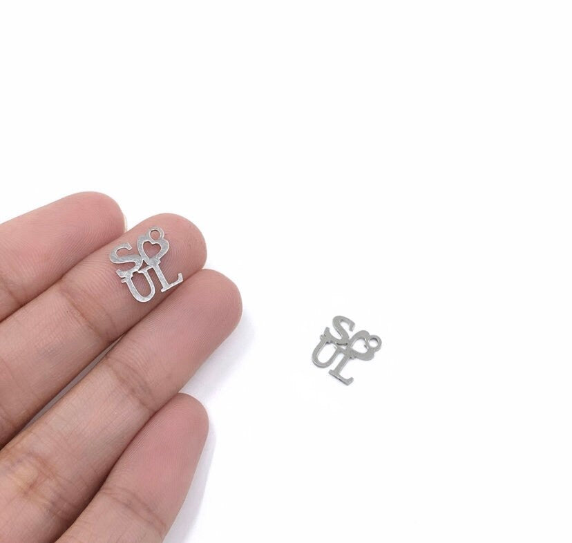 Soul writing charm shown on hand for reference