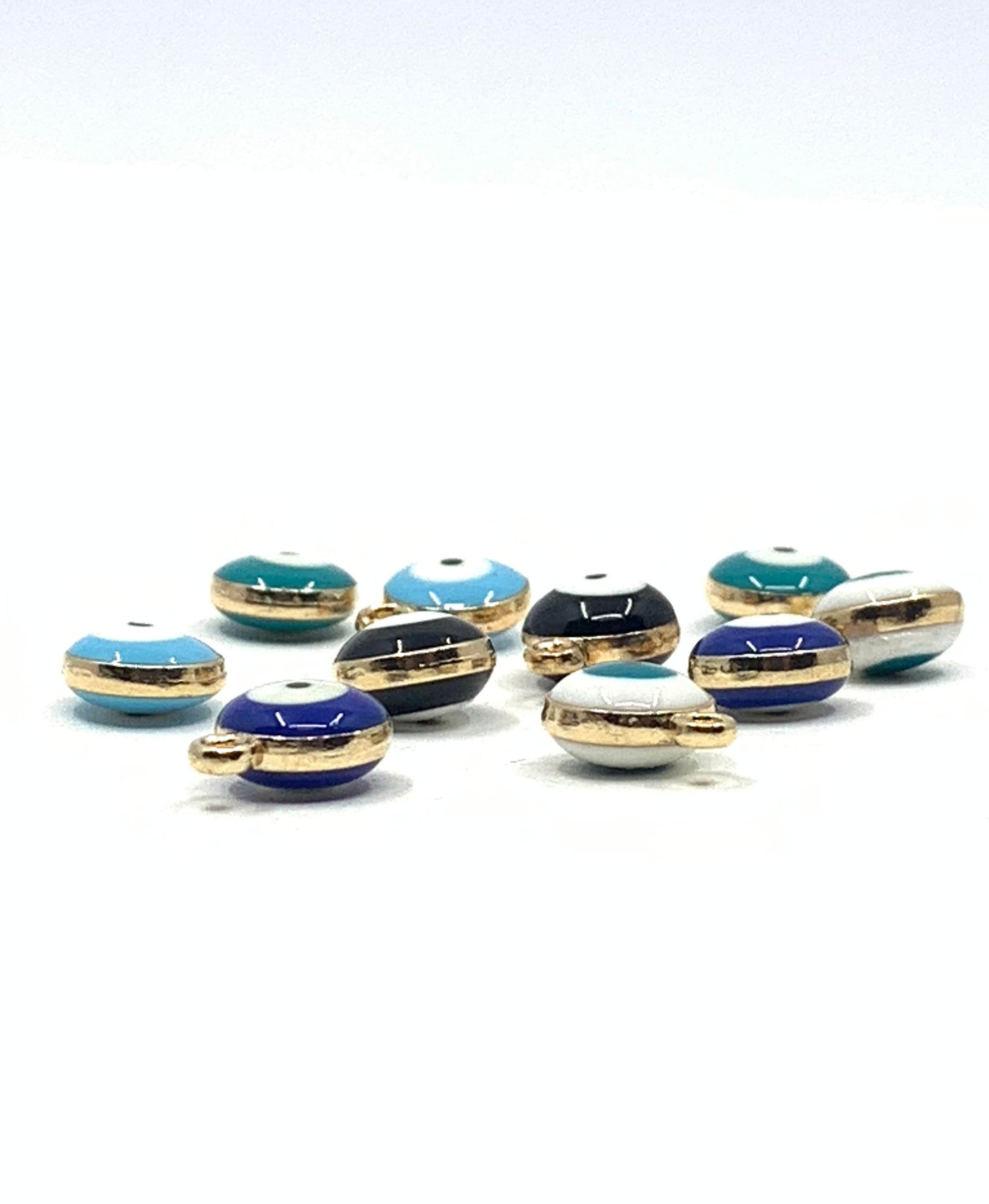 Camera angle showing the thickness of evil eye charms. Puffy charms.