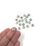 Evil eye beads shown on hand for size reference
