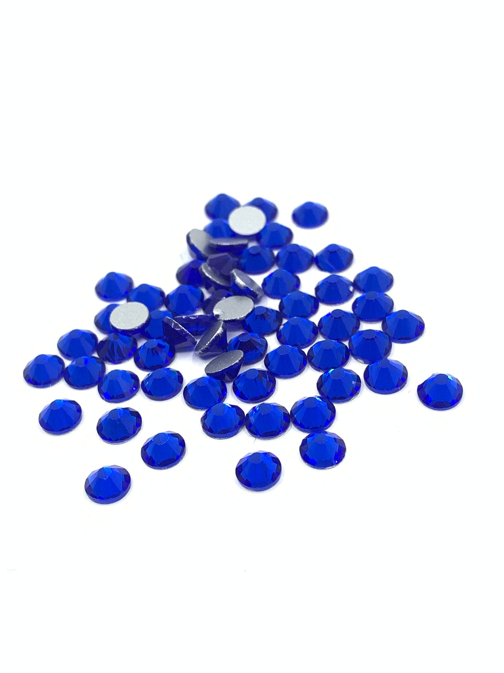 Royal blue rhinestone flatbacks against a white background 