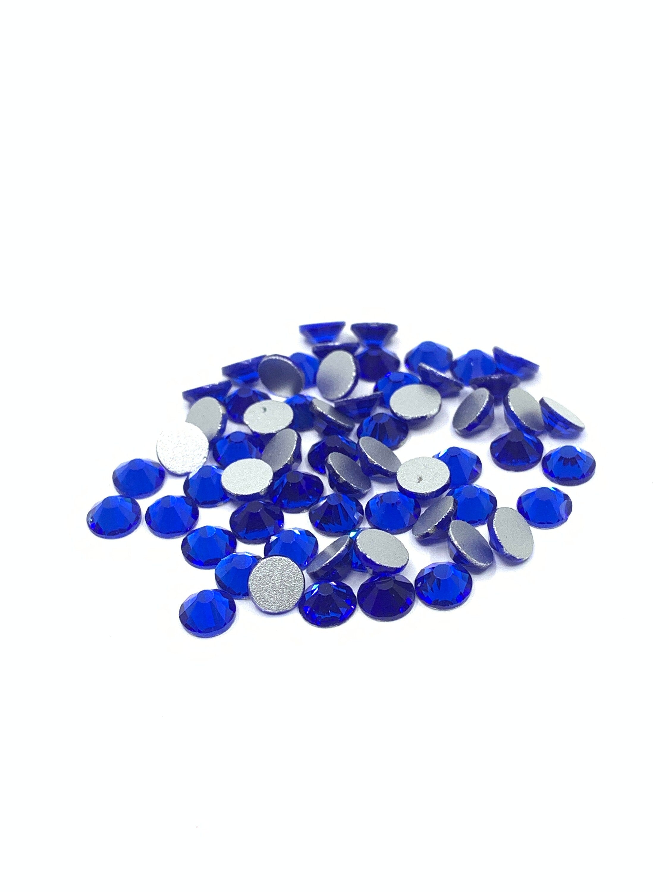 Royal blue rhinestone flatbacks against a white background