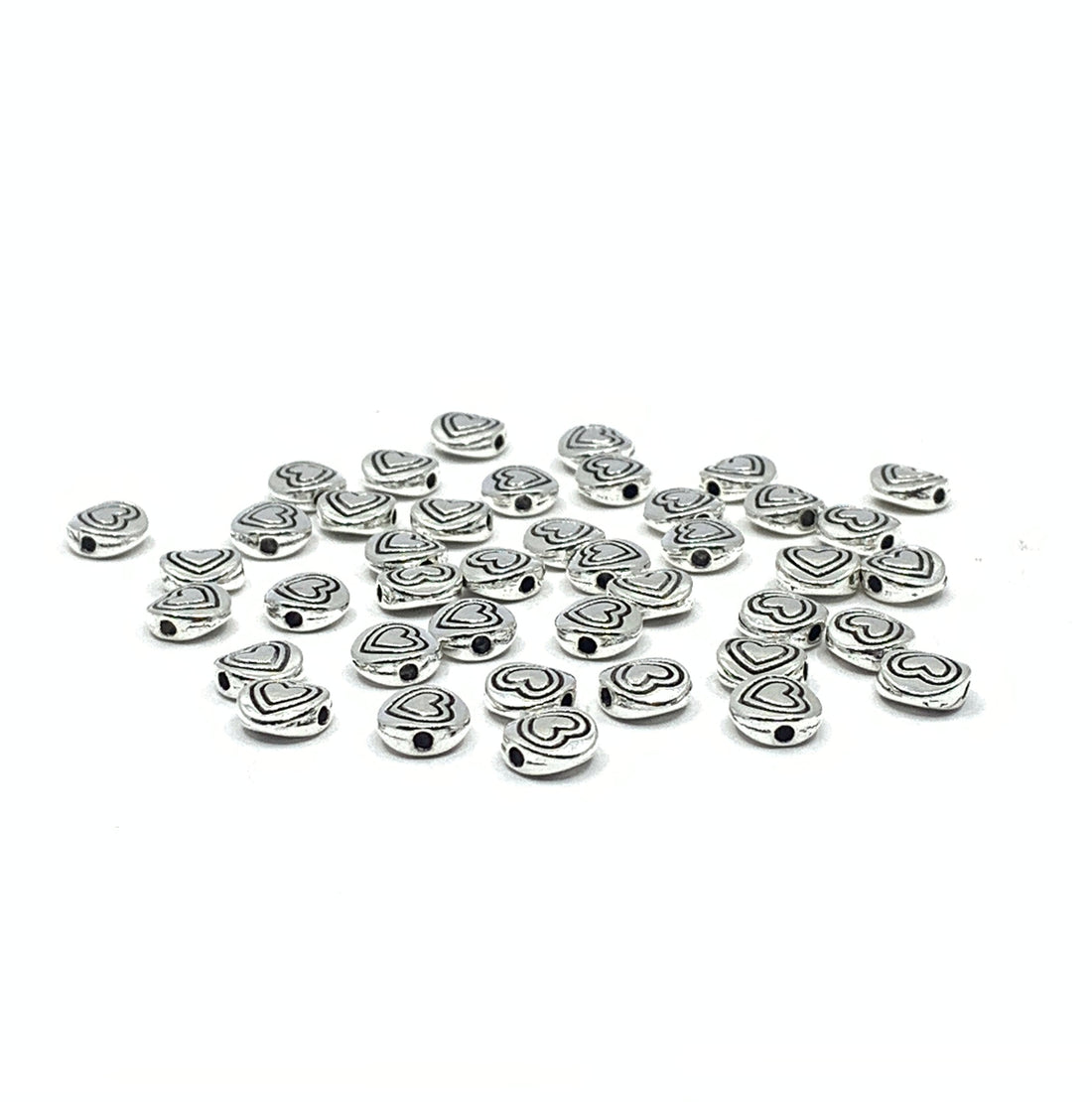 40 heart beads, flat round shape. Heart in heart pattern drawn on beads.